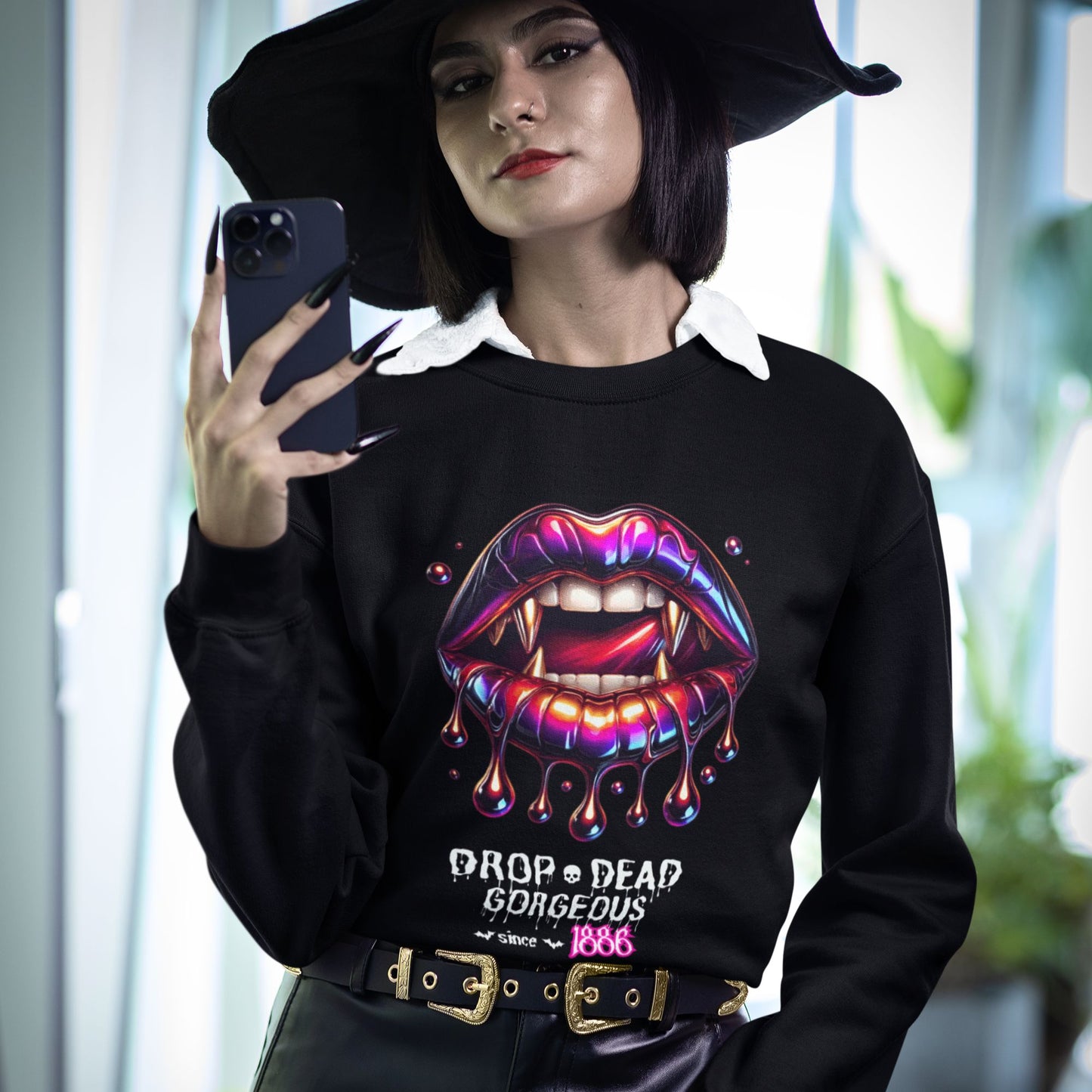 Drop-dead Gorgeous Sweatshirt in black, made from organic cotton. Witchy model showcasing the sweatshirt while taking a selfie.