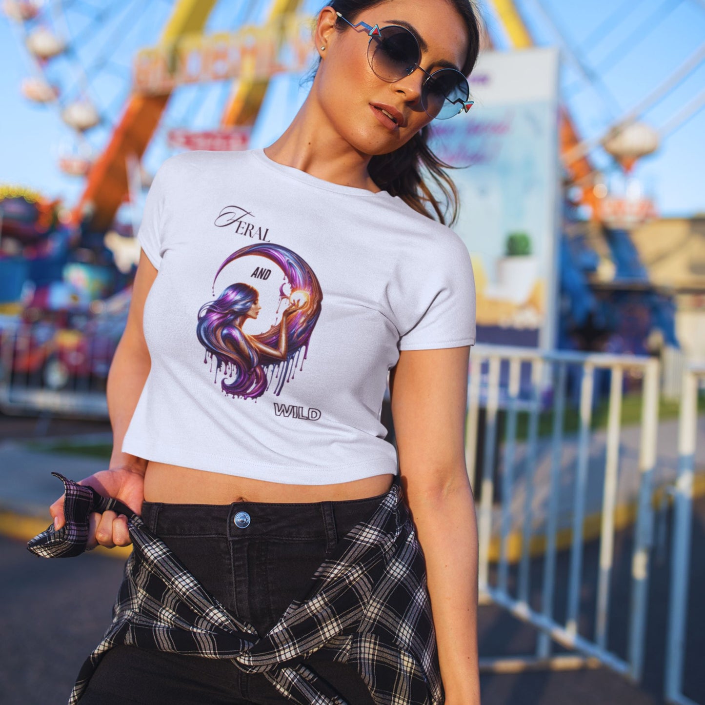 Feral and wild crop top in white, made from organic cotton. Female model in sunglasses showcasing the crop top in a lifestyle setting.