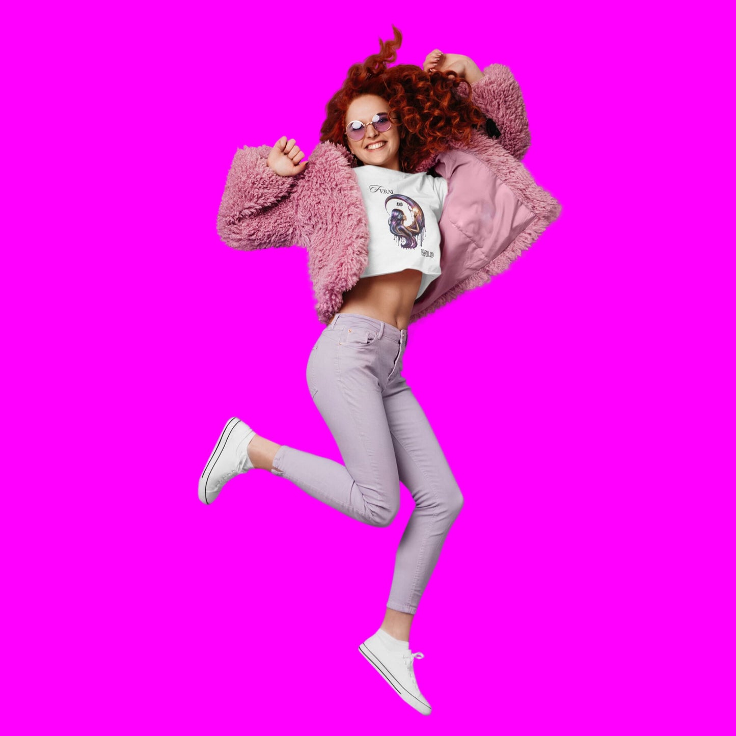 Feral and wild crop top in white, made from organic cotton. Red haired model showcasing the crop top in a jumping position.