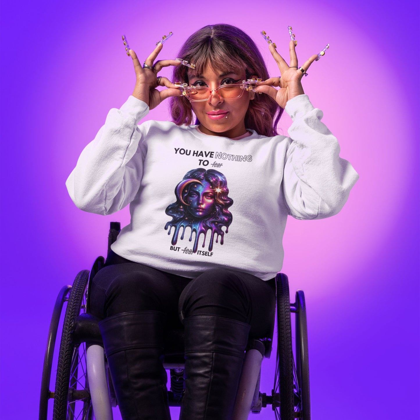 Nothing to fear Hoodie hers in white, made from organic cotton. Female model in wheelchair showcasing hoodie in studio setting.