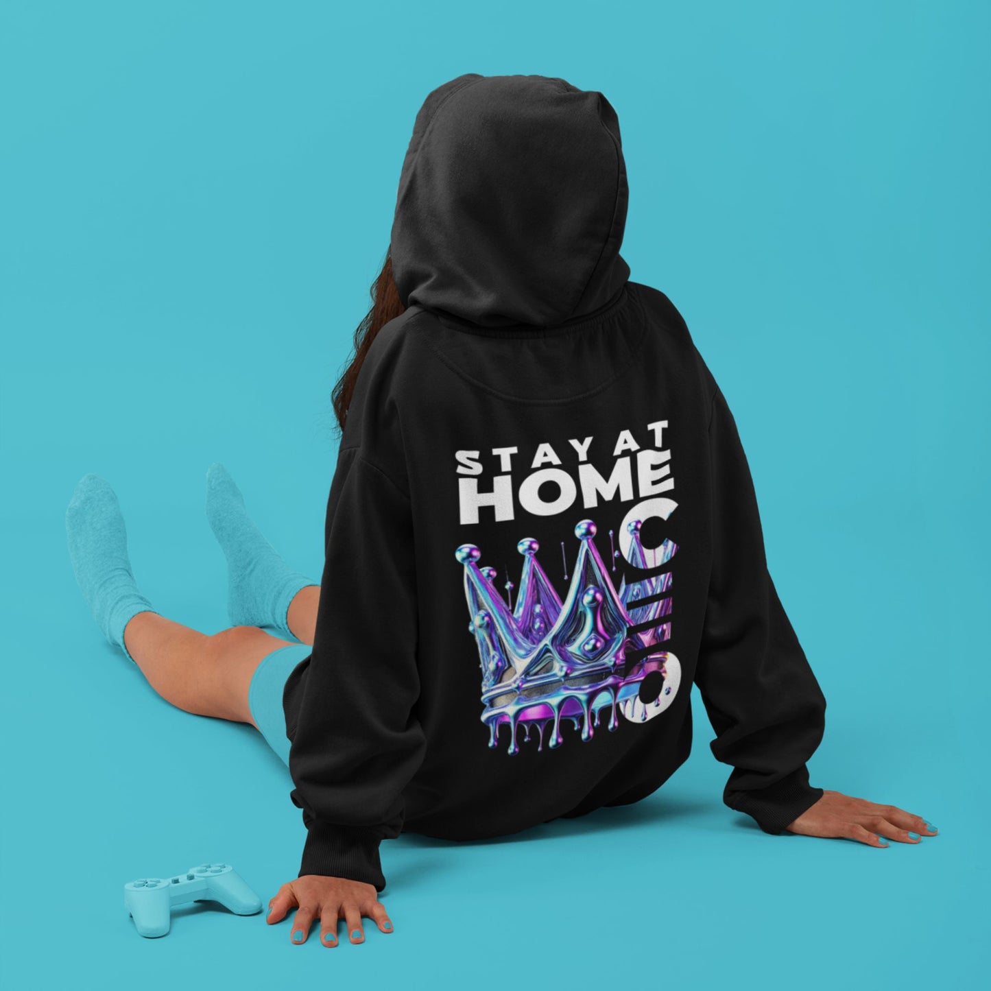 Stay at Home CEO Hoodie in black, made from organic cotton. Back view of model showing print in sitting position.