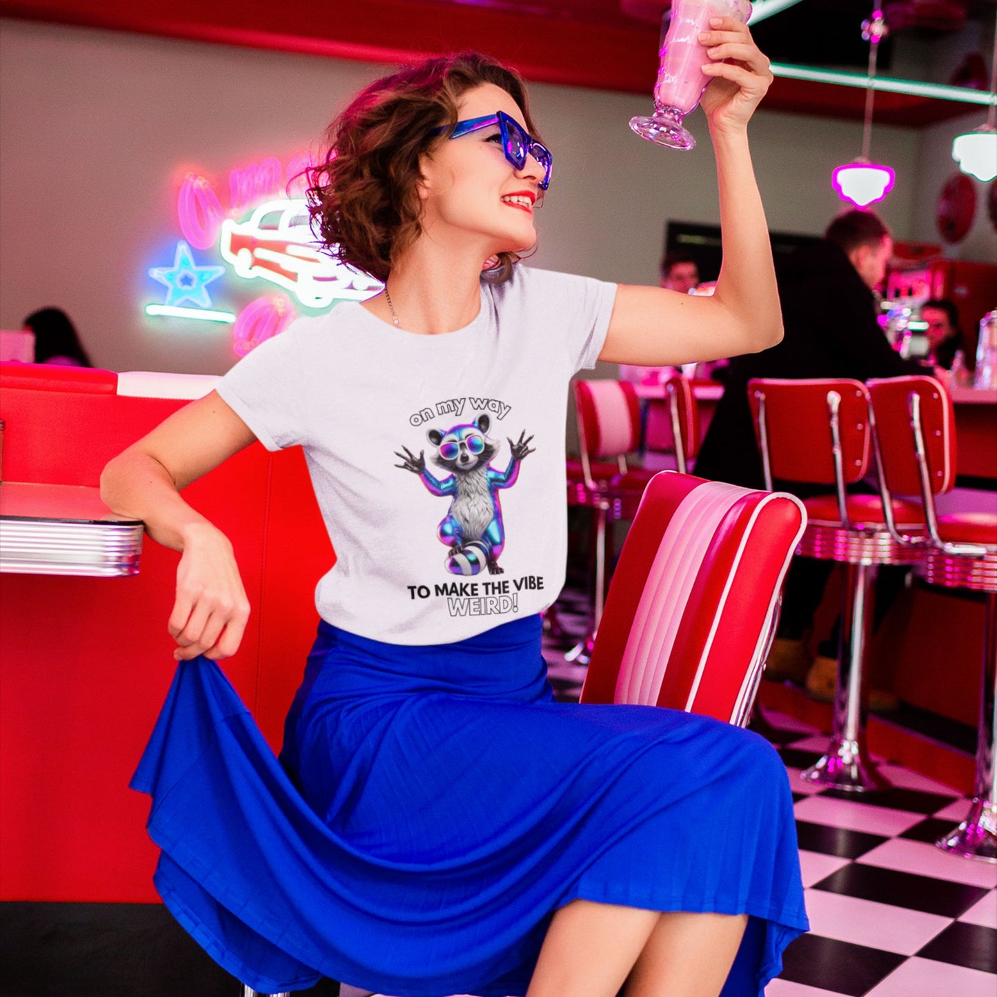 On my way to make the vibe weird Raccoon Shirt in white, made from organic cotton. Lifestyle image of model showcasing front print.