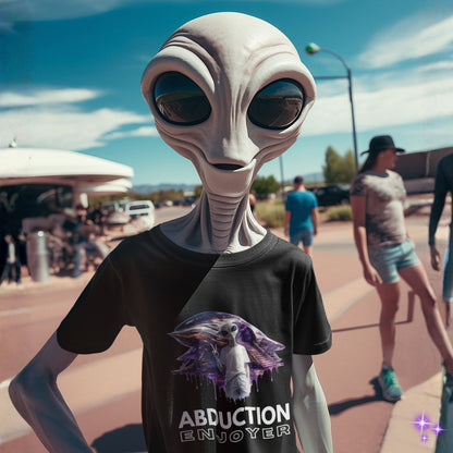 Alien wearing a t-shirt with an alien graphic and 'Abduction Enjoyer' text on a street.