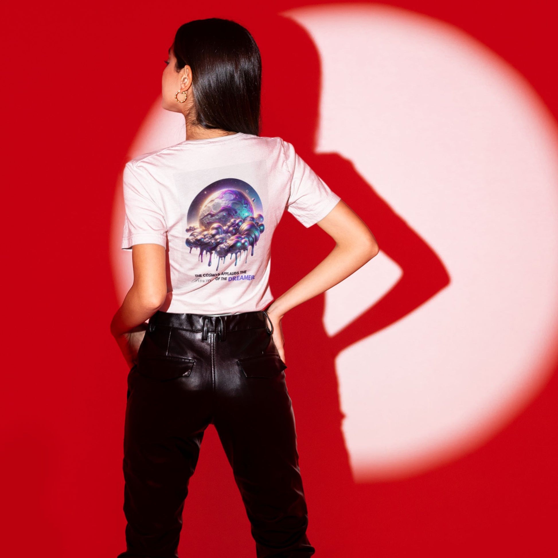 Audacity of the Dreamer Shirt in white, made from organic cotton in conversion. Model in vegan leather pants showcasing shirt on a red studio light.