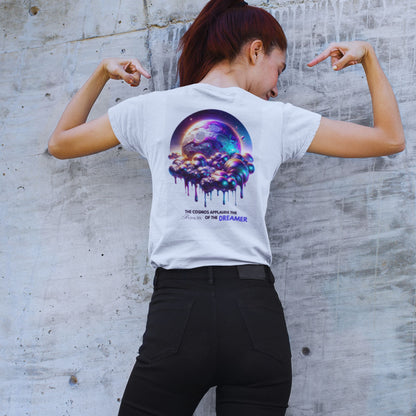 Audacity of the Dreamer Shirt in white, made from organic cotton in conversion. Model showcasing the back view of the shirt while pointing at the print.