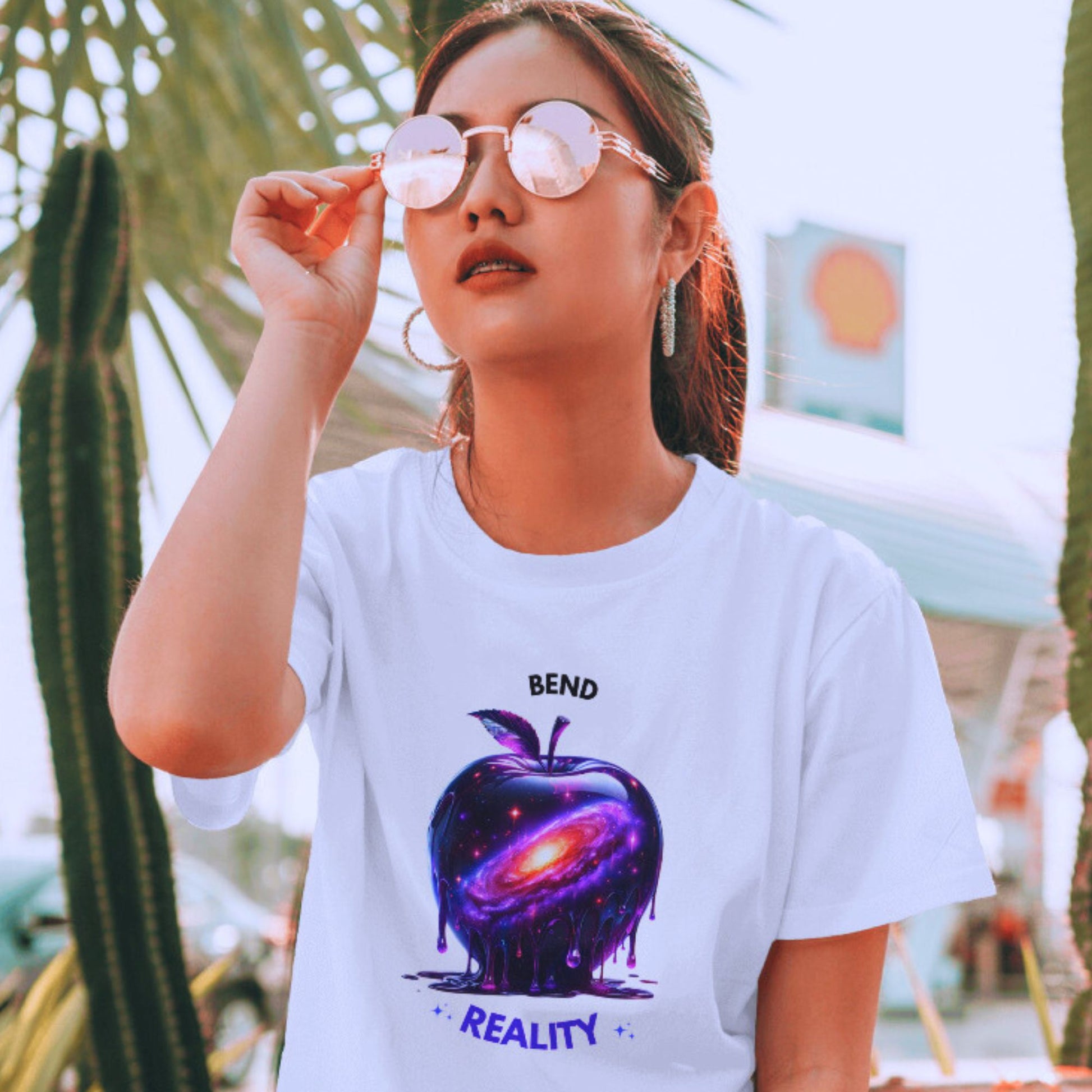 Bend Reality Shirt in white, made from organic cotton in conversion. Model in sunglasses showcasing the shirt in a lifestyle setting.