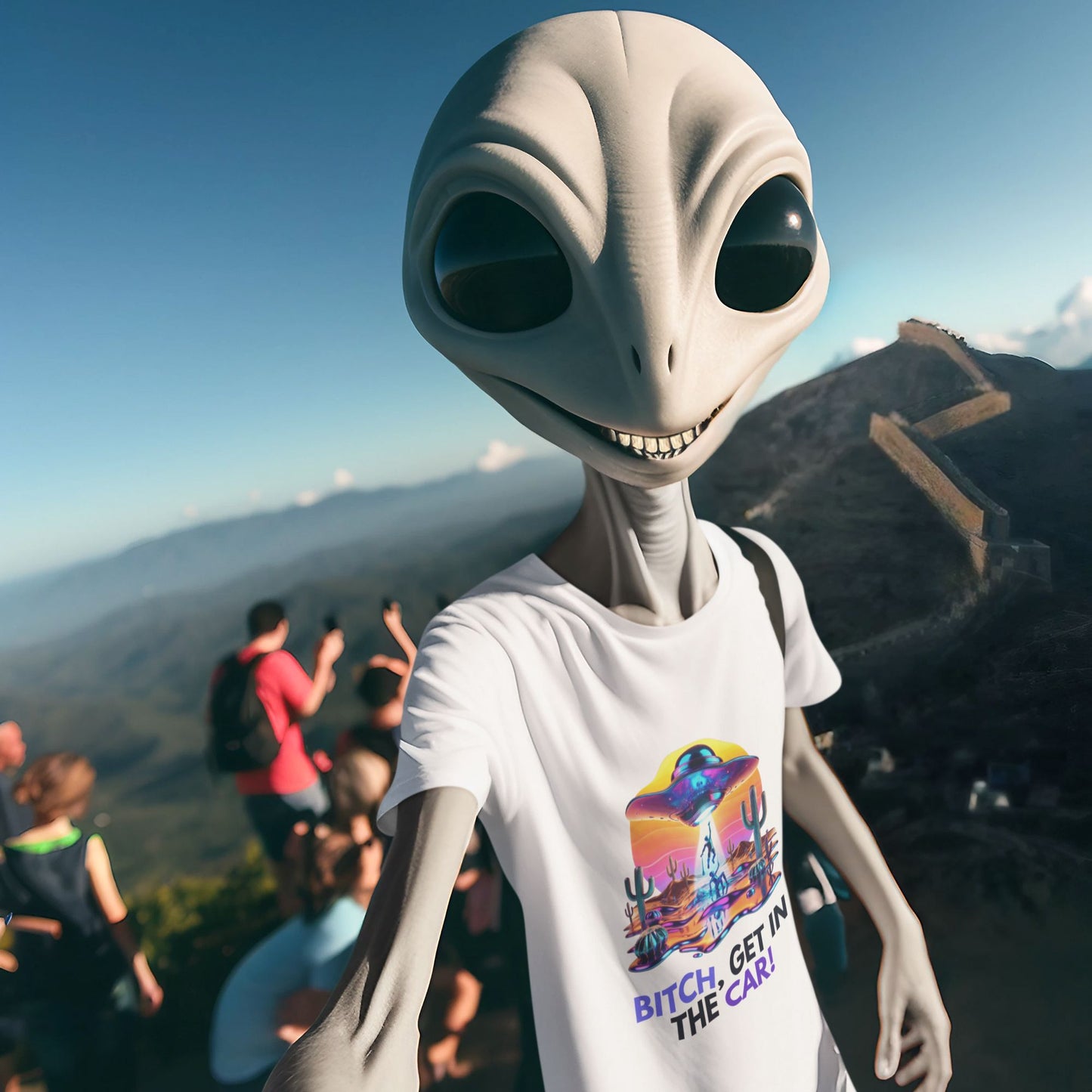 Bitch, get in the car Alien Abduction Shirt in white, made from organic cotton. Grinning alien wearing the shirt taking a selfie in front of a mountain.