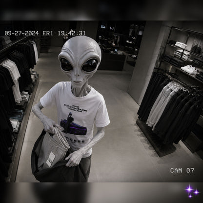 Alien figure wearing a t-shirt in a store setting with a timestamp overlay.