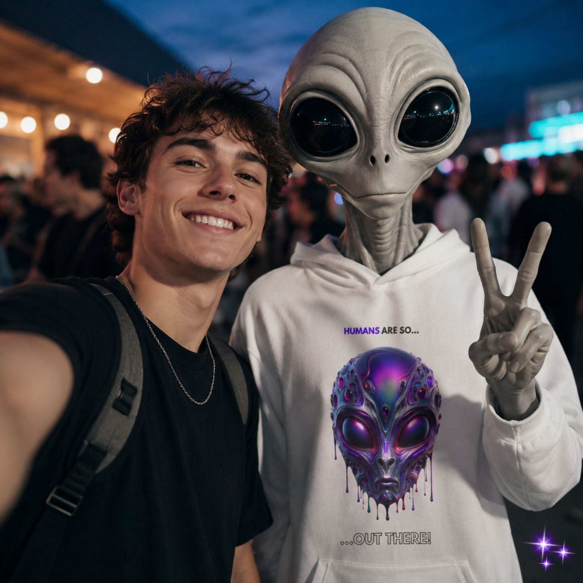 Person taking a selfie with an alien wearing a hoodie with an alien design.