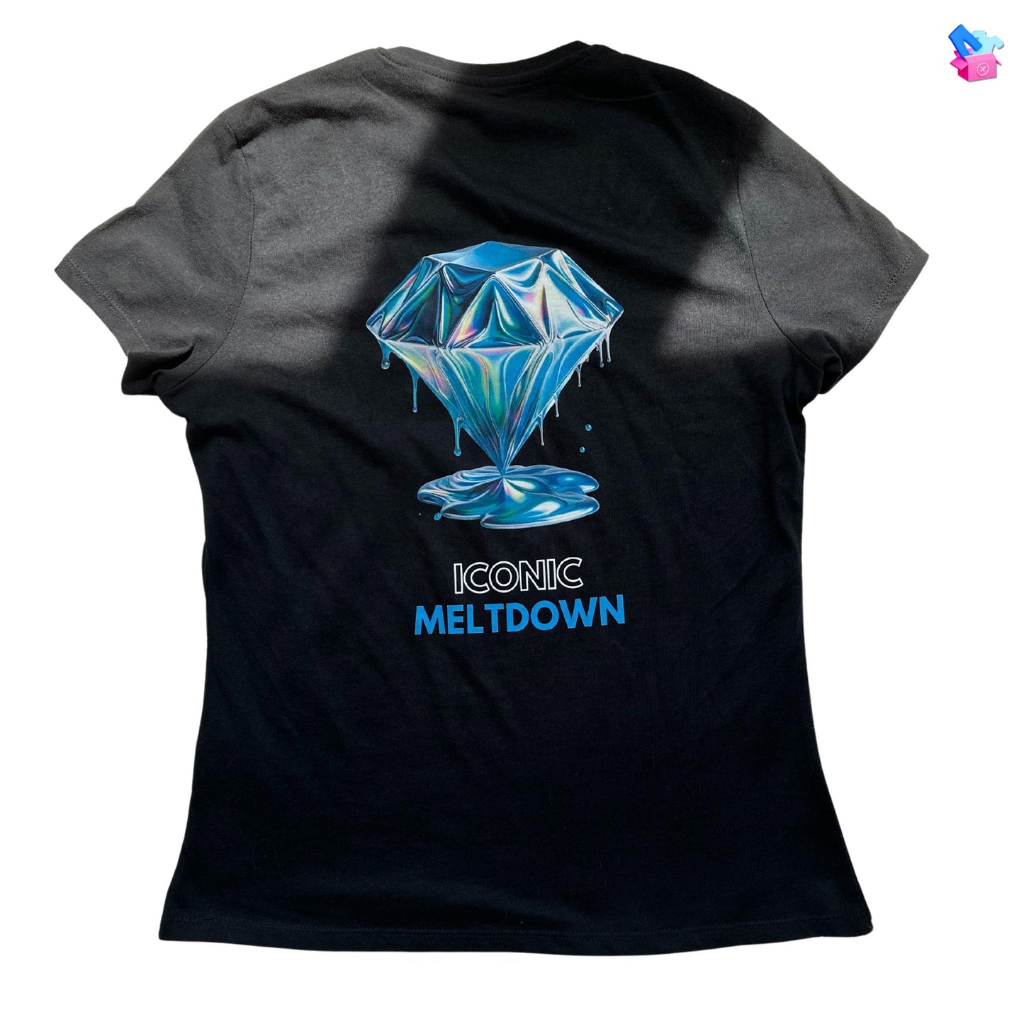 Iconic Meltdown Shirt showcasing the image of a melting diamond in black, made from organic cotton in conversion. Back view showing print on a flat surface.