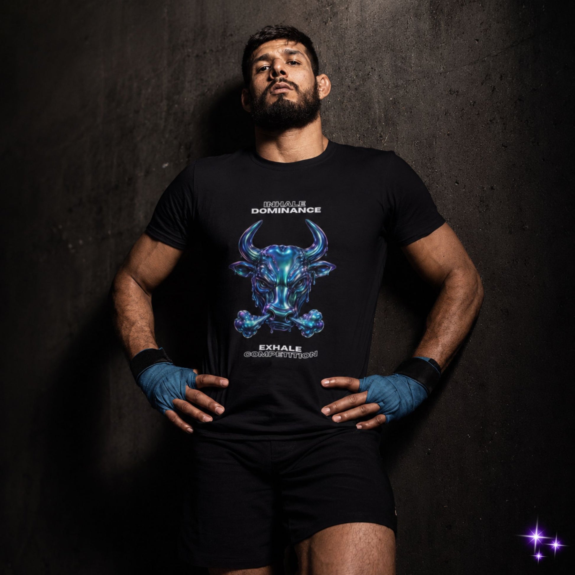 Man wearing a black t-shirt with a blue graphic design on a dark textured background