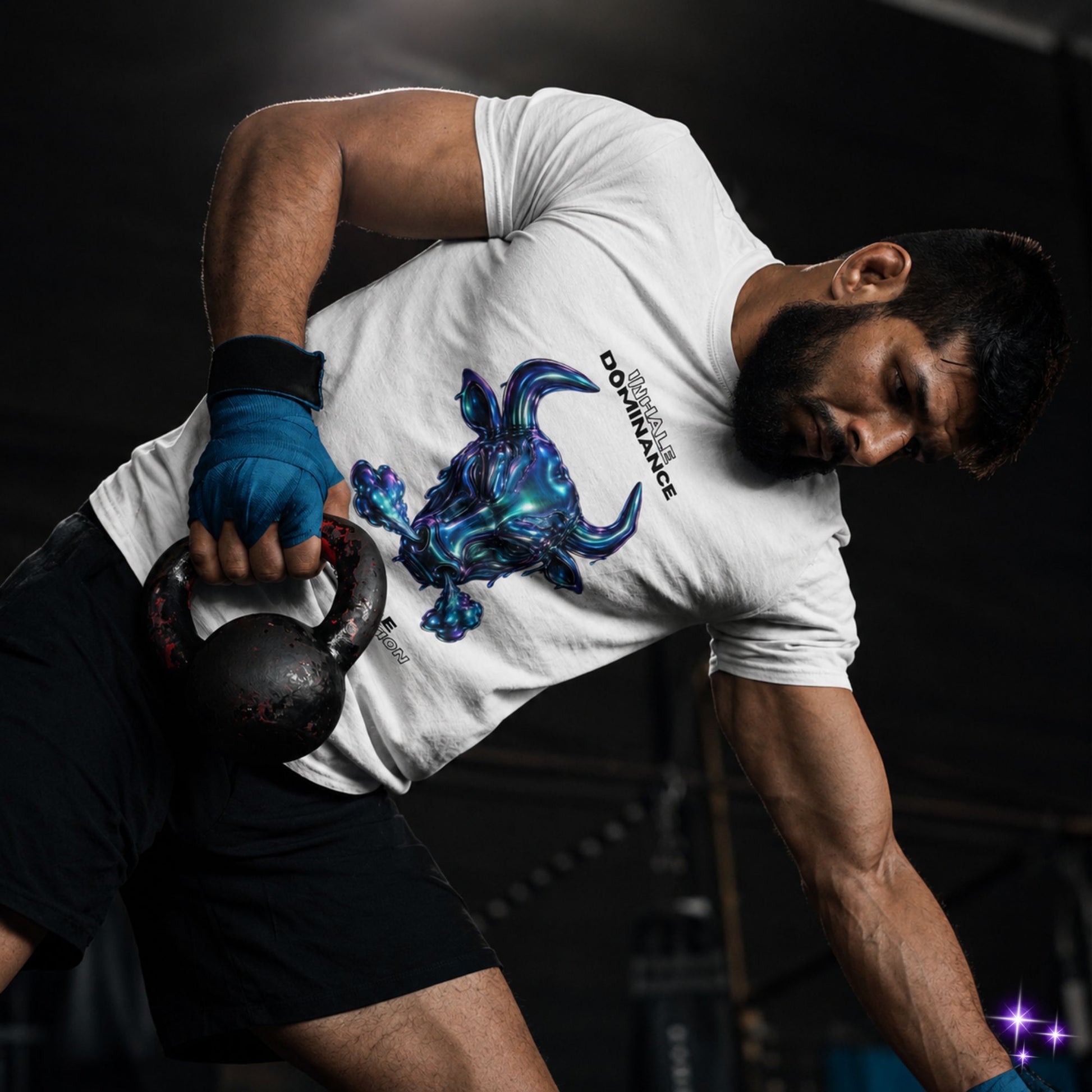 Person lifting a kettlebell wearing a white t-shirt with a blue graphic design.