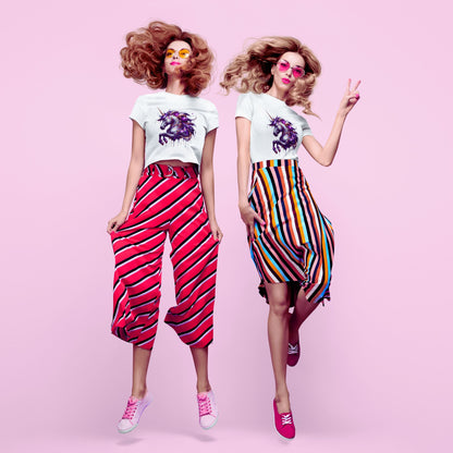 Melting Unicorn crop top in white, made from organic cotton. Front view showcased by two female models dressed in 70s inspired attire and the crop top.