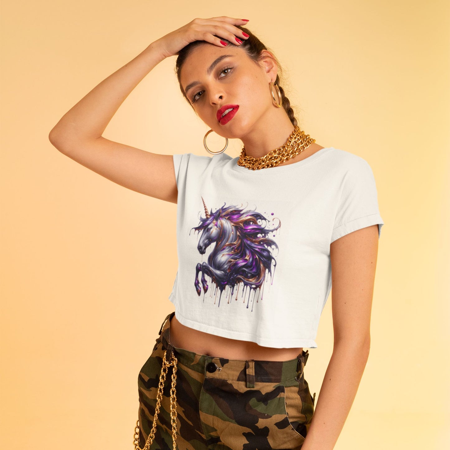 Melting Unicorn crop top in white, made from organic cotton. Female model showcasing the crop top in a studio setting. 