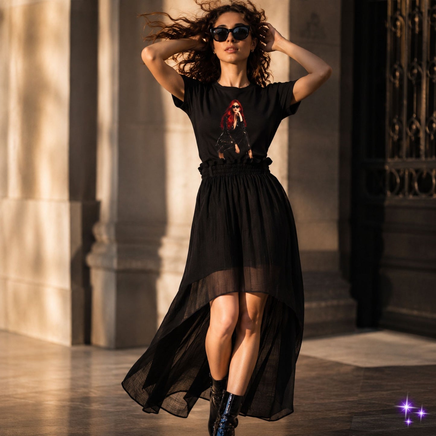Woman wearing a black dress with a graphic design, standing outdoors.