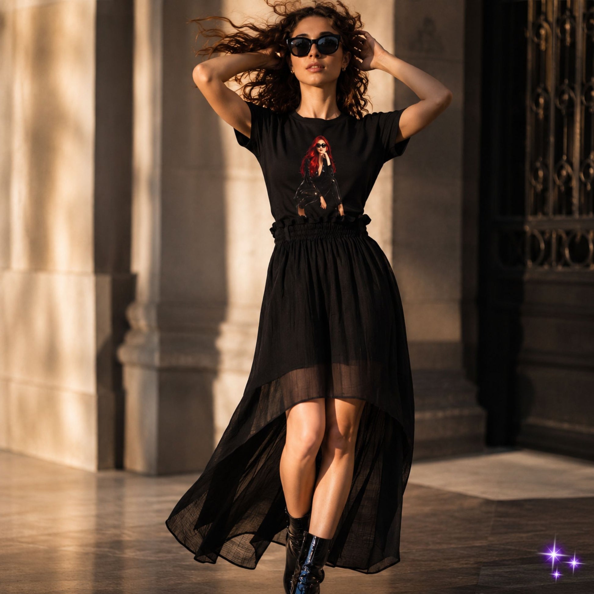 Woman wearing a black dress with a graphic design, standing outdoors.