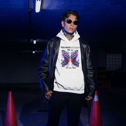 Nothing to fear Hoodie his in white, made from organic cotton. Model in sunglasses and a vegan leather jacket showcasing the hoodie in an underground setting.