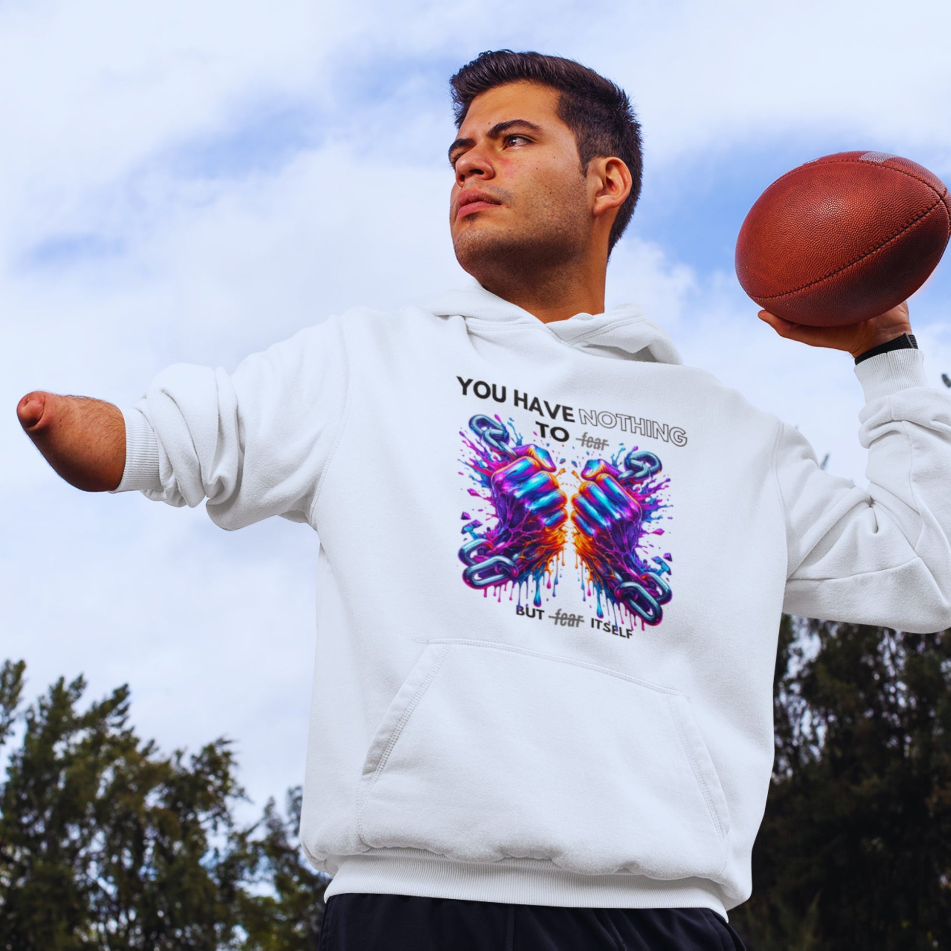 Nothing to fear Hoodie his in white, made from organic cotton. Disabled male model showcasing the hoodie while playing football.