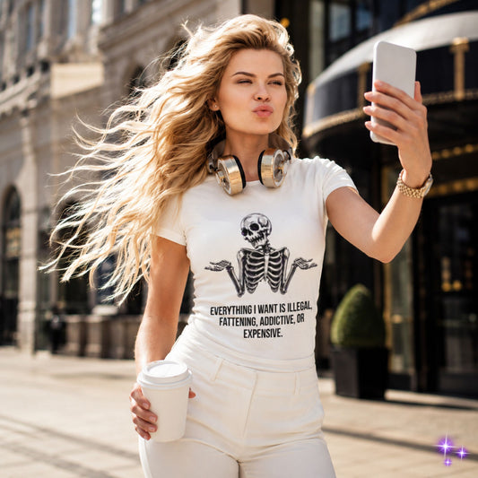 Woman taking a selfie on a city street wearing a white t-shirt with a skeleton design and text.