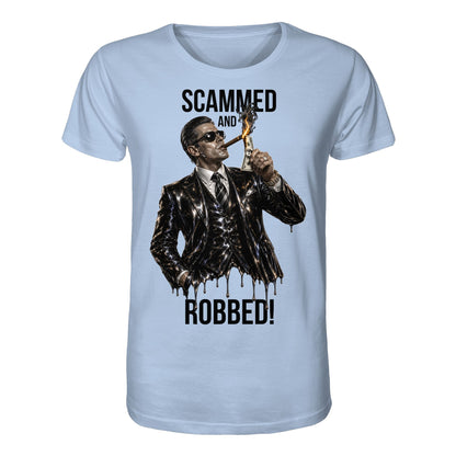 Light blue t-shirt with a graphic of a man in a suit and sunglasses, holding a dollar bill, with text 'Scammed and Robbed!' on a white background.