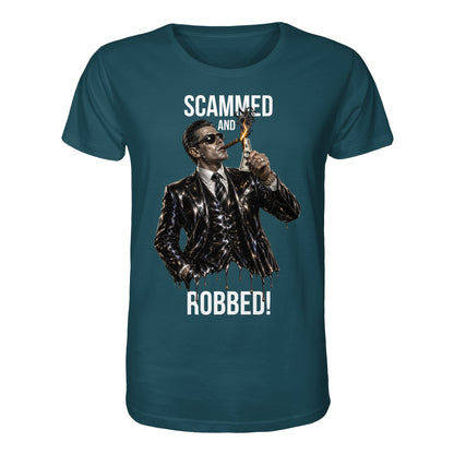 Teal t-shirt with graphic of a man in a suit and sunglasses holding a dollar bill, with text 'Scammed and Robbed!' on a white background.
