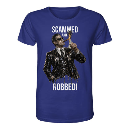 Blue t-shirt with a graphic of a man in a suit and sunglasses, holding a dollar bill, with text 'Scammed and Robbed!' on a white background.